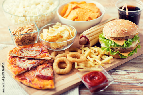 close up of fast food snacks and drink on table photo