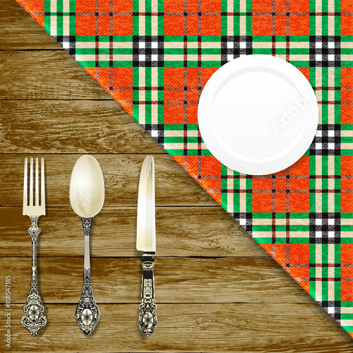 cutlery on wood table. vintage plate, fork, knife, napkin