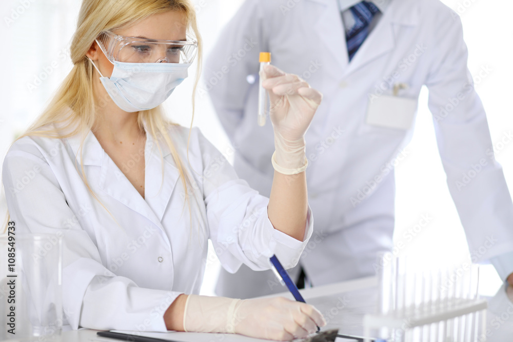 Scientific research team with clear solution in laboratory Scientific research team with clear solution in laboratory