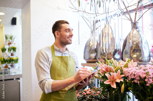 florist man with clipboard at flower shop photo