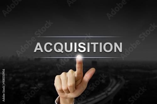business hand pushing acquisition button  photo
