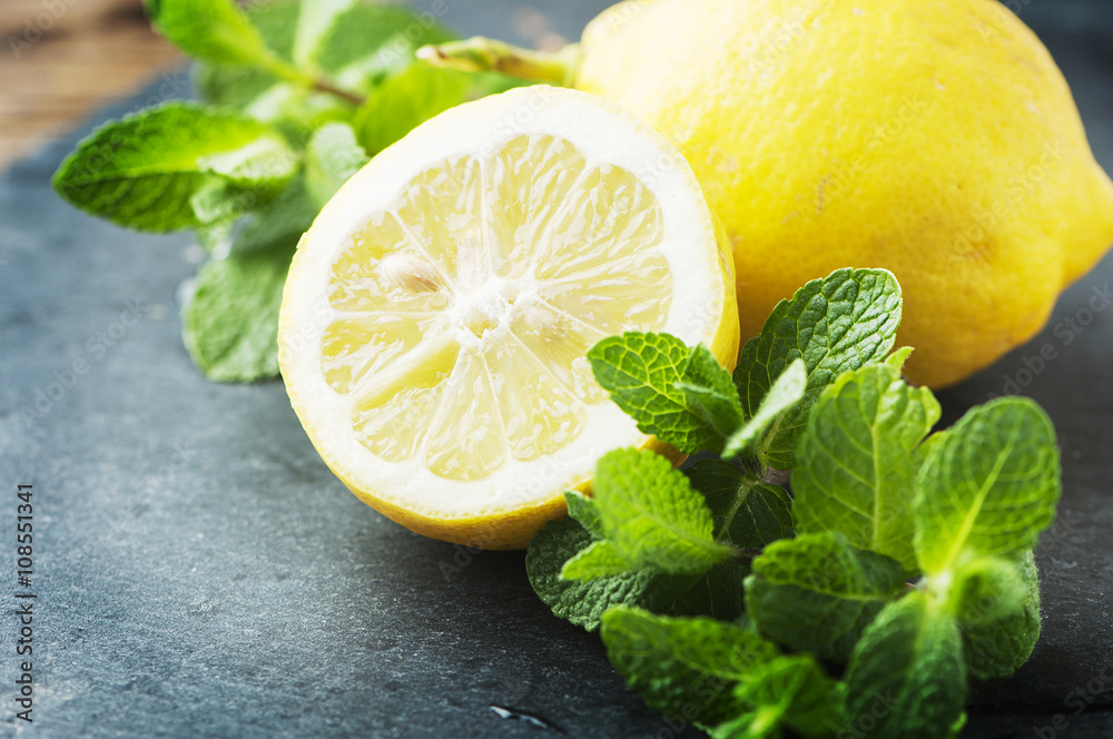 Fresh lemon and green mint on the table Fresh lemon and green mint on the table