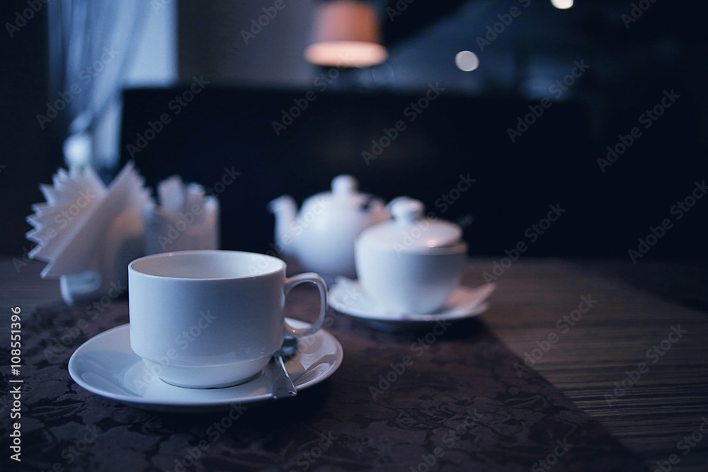 Fototapeta premium teapot and cup of tea at a cafe
