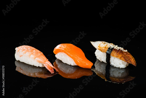 assortment of nigiri sushi on a dark background photo