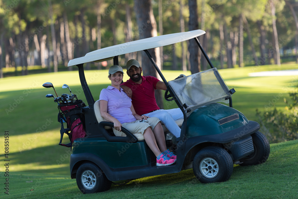 couple in buggy on golf course couple in buggy on golf course