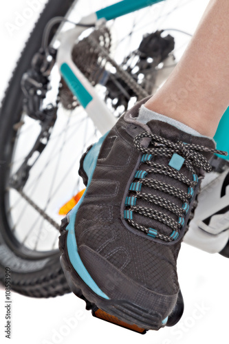 Close up foot of the cyclist pedalling mountain bike. photo