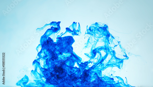 a swirl of blue ink in clear water