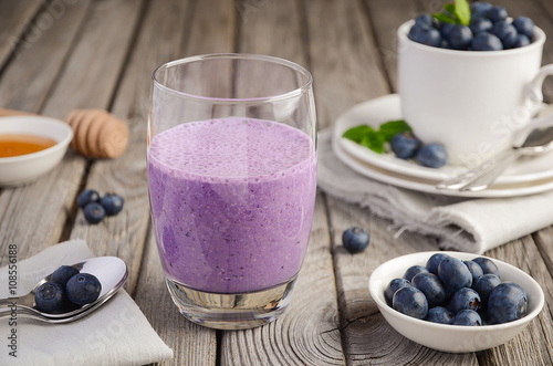 Blueberry and banana smoothie with oatmeal on the rustic wooden table  selective focus  copy space