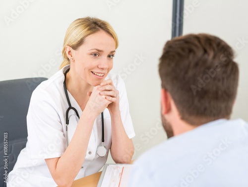 Young attractive woman doctor listening his patient