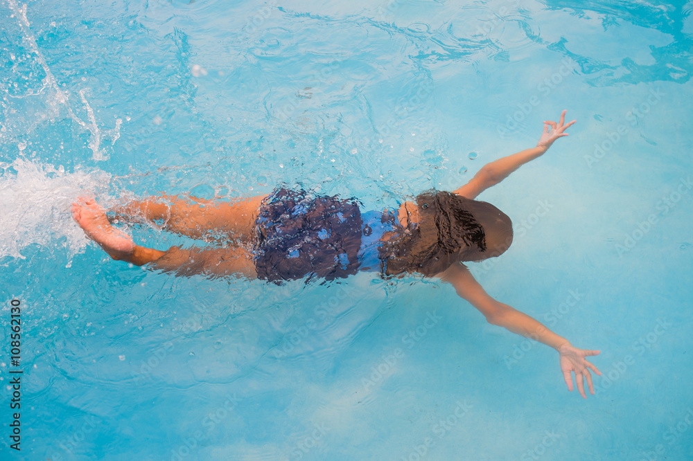 Children swim in pool underwater, happy active girls have fun in water
