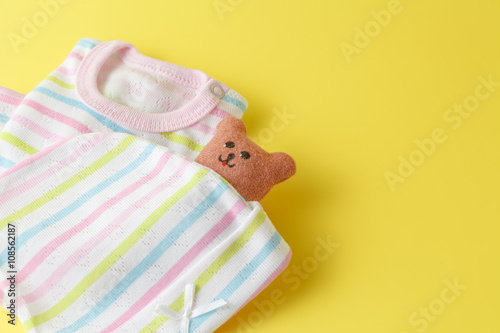 Baby clothing on a yellow background photo