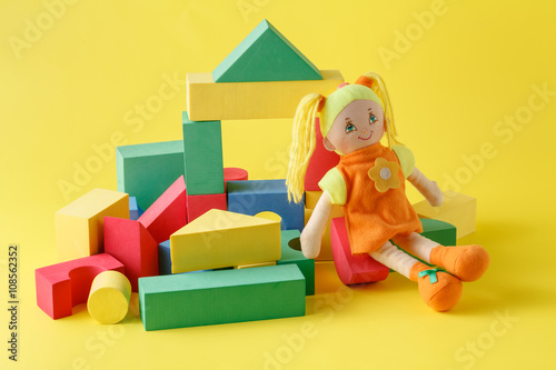 Toy house and doll with blocks