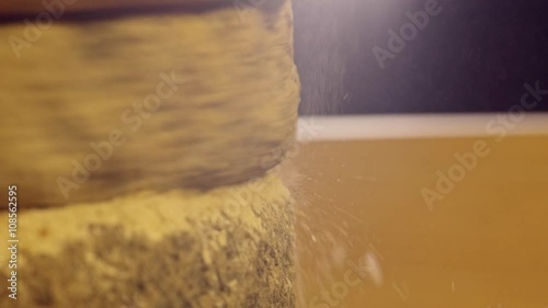 Close-up shot of historic hand-driven millstone grinding wheat photo