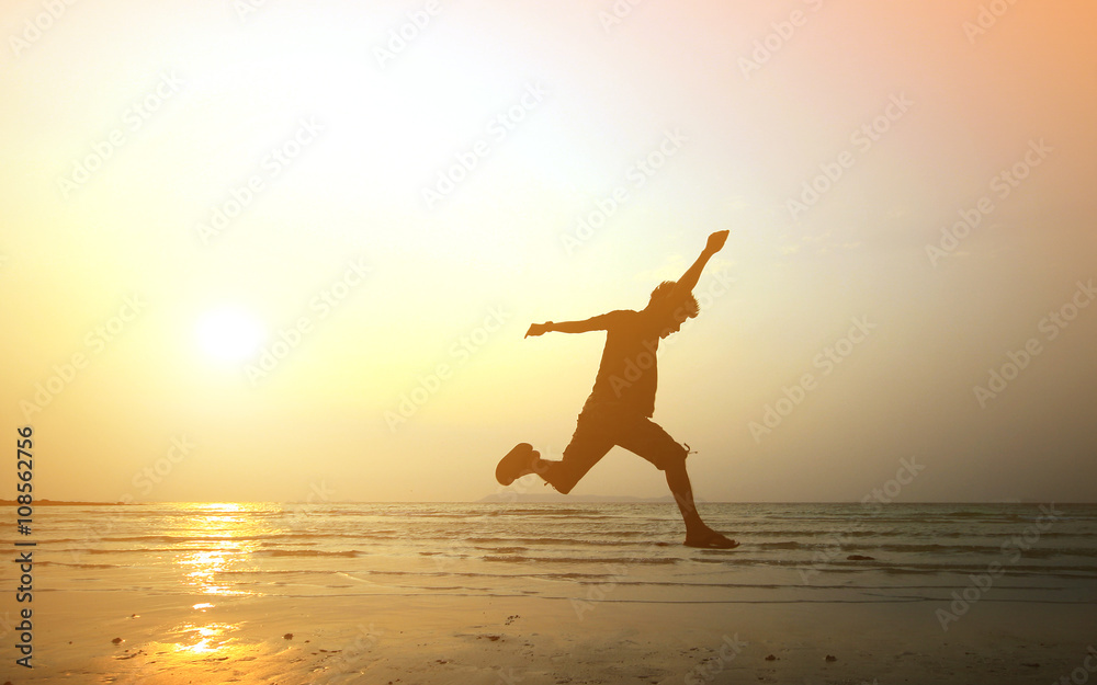 silhouette of a man jumping on the freedom beach. summer holiday