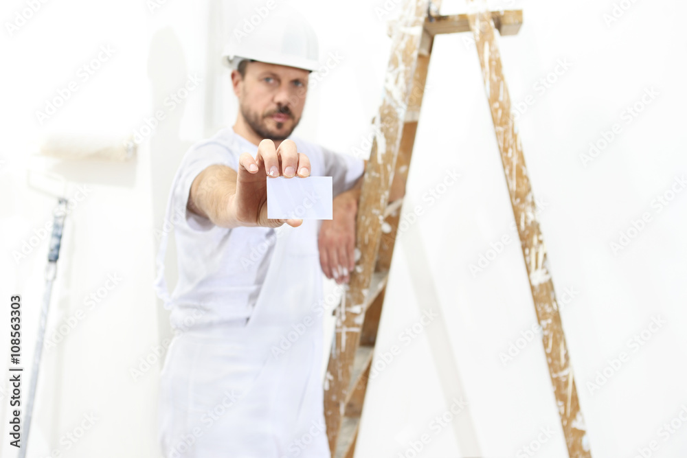 painter man hand with business card, ladder on white wall background painter man hand with business card, ladder on white wall background