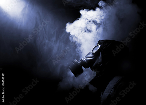 Man in gasmask with abstract smoke 
