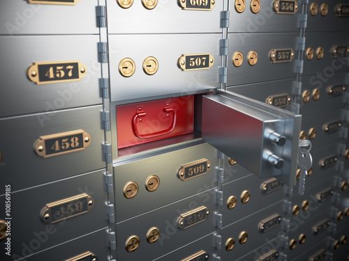 Safe deposit boxes with open one safe cell.