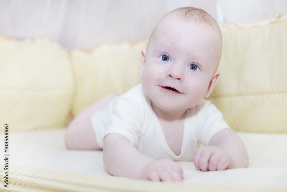 Lying baby in his bed