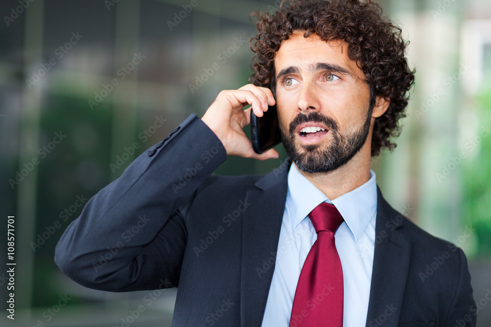 Handsome businessman talking on the cellphone Handsome businessman talking on the cellphone