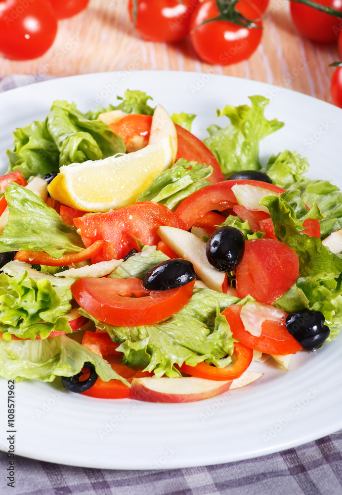 Fresh vegetable salad on the wooden table