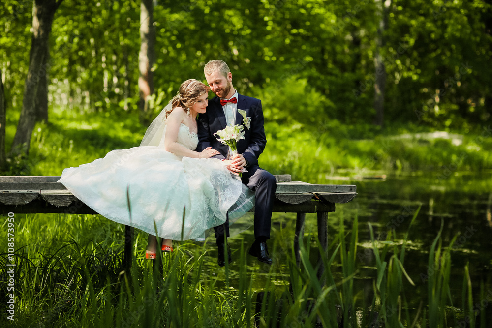 wedding couple in the woods near the lake.