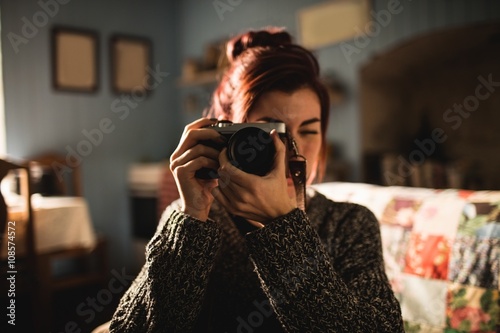 Young woman taking a picture with her camera