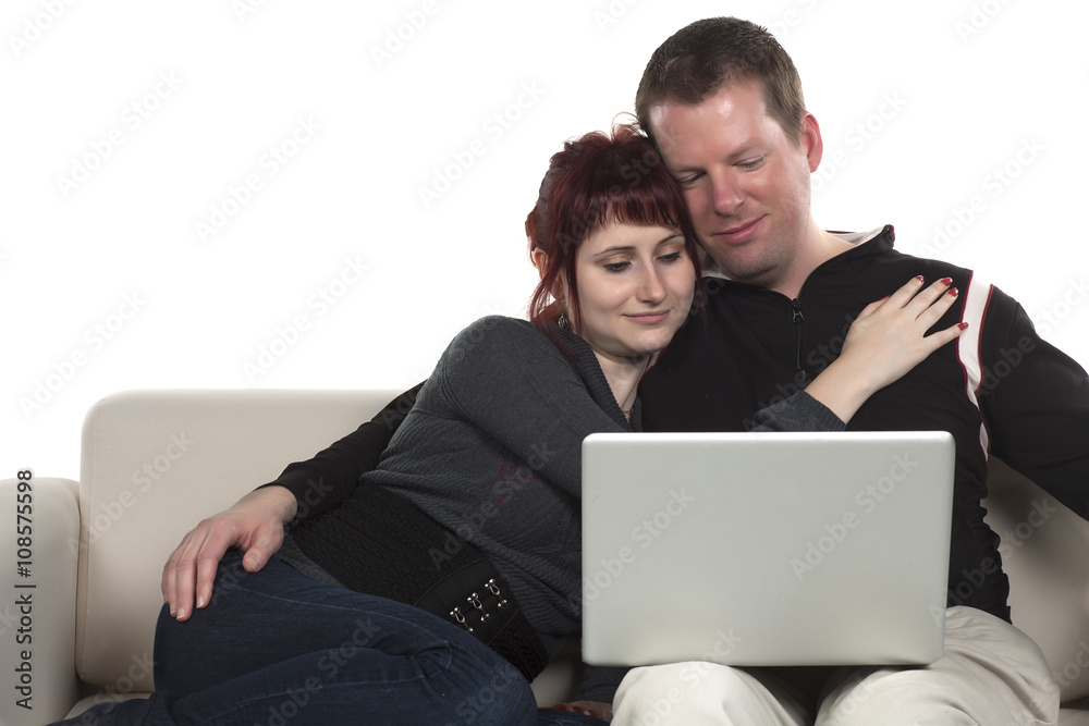 sweet couple looking at their laptop