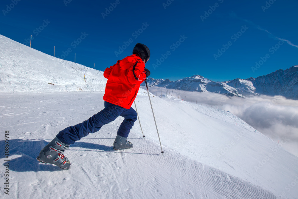 Young skier warming-up before skiing in Elm ski resort, Switzerland Young skier warming-up before skiing in Elm ski resort, Switzerland