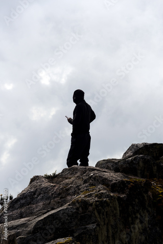 silhouette of single person on suimmit in ruwenzori mountains  uganda