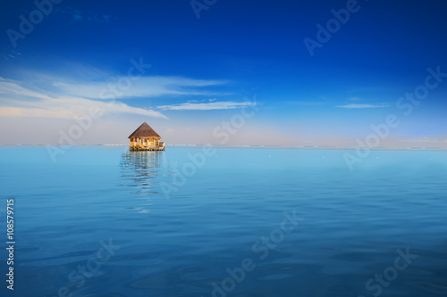 Overwater bungalows with tourquise clear water in tropical island photo