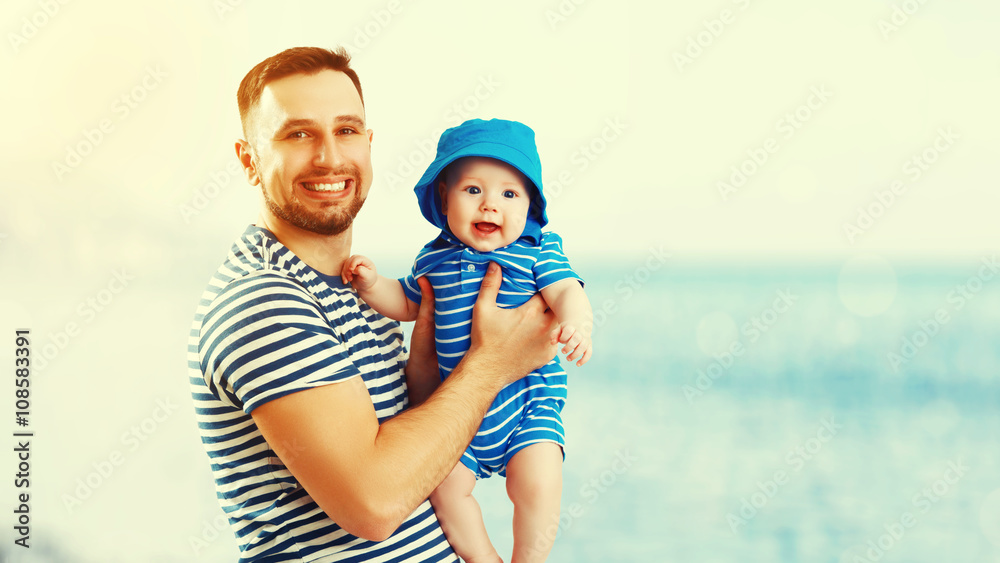 happy family father and baby son on beach by sea at sunset happy family father and baby son on beach by sea at sunset