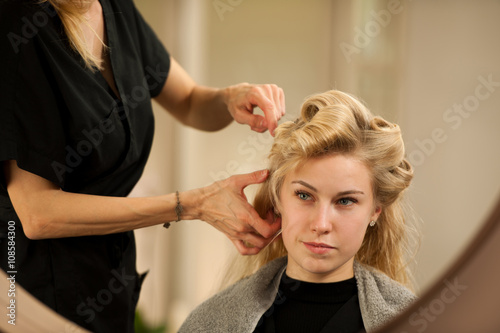 professional hair stylist at work - hairdresser doing hairstyle