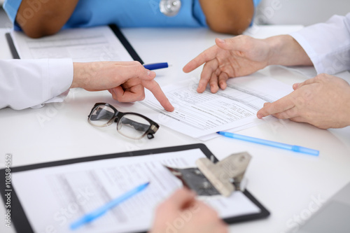 Group of doctors discuss at meeting