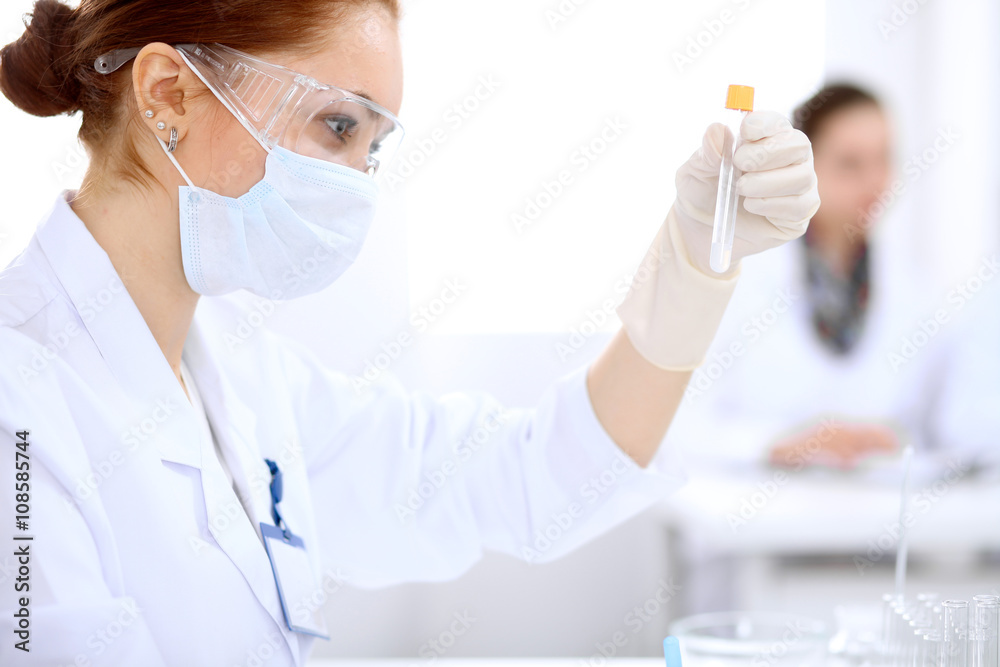 Scientific research team with clear solution in laboratory Scientific research team with clear solution in laboratory