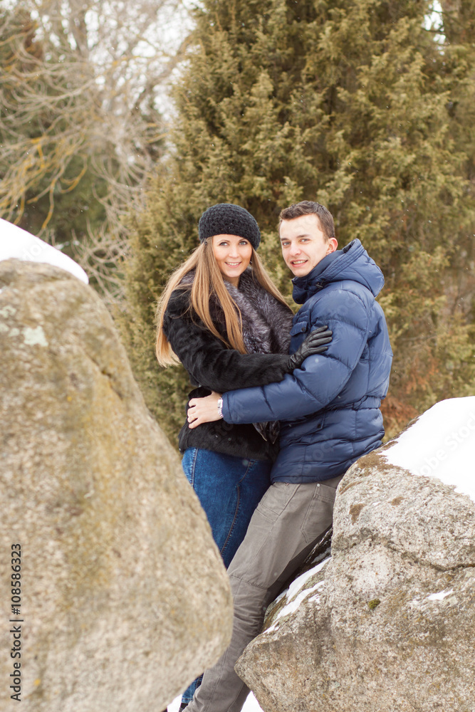 Naklejka premium Happy Young Couple in Winter mountains