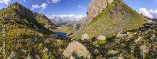 Panorama of a mountain valley with hills and lake in the summer sunny day in Abkhazia