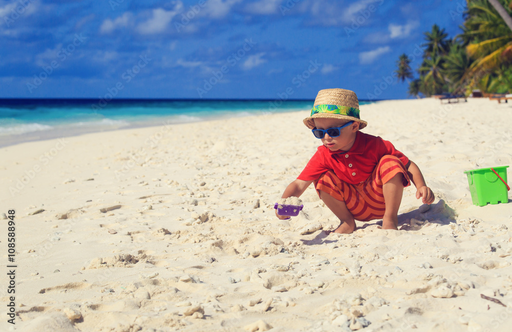 little boy play with sand on beach little boy play with sand on beach