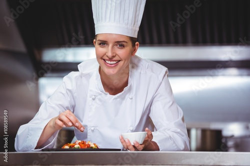 Photography Chef sprinkling spices on dish