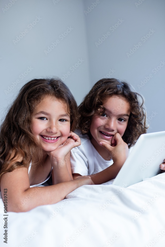 Portrait of brother and sister using digital tablet Portrait of brother and sister using digital tablet
