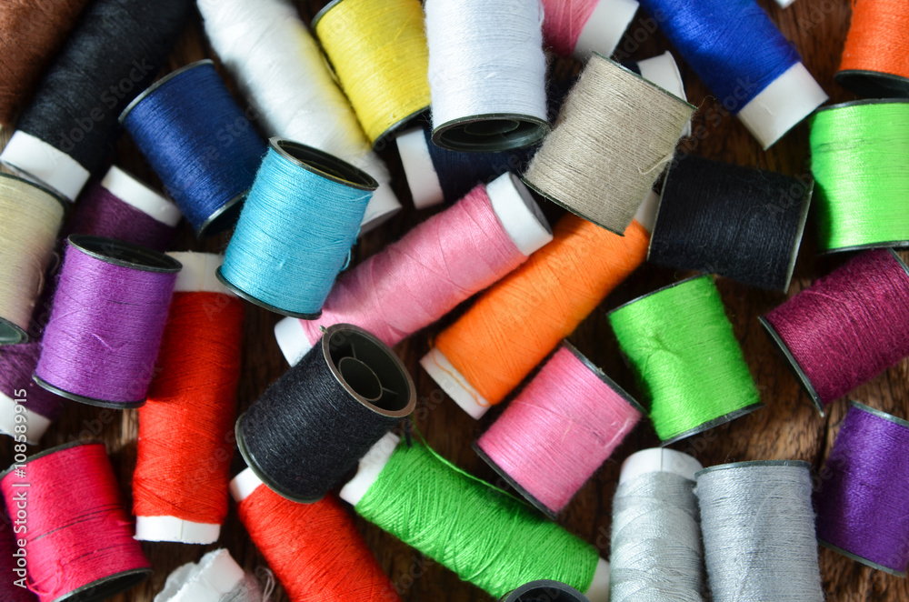 colored spools of threads colored spools of threads
