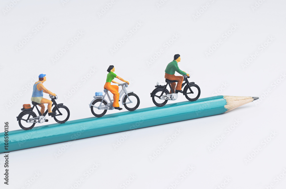 Obraz premium Miniature people cycling on pencil