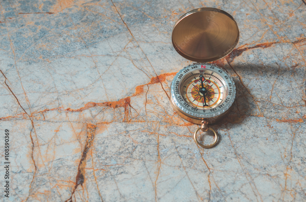 Compass on marble stone background Compass on marble stone background