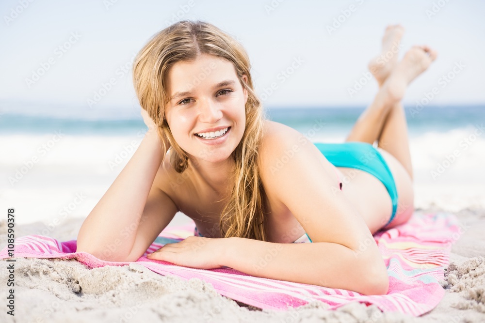 Portrait of happy woman in bikini lying on the beach Portrait of happy woman in bikini lying on the beach