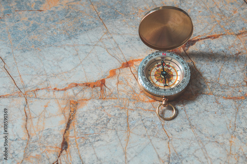 Compass on marble stone background