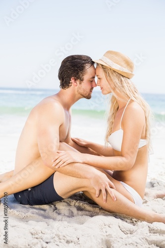 Young couple sitting face to face and romancing