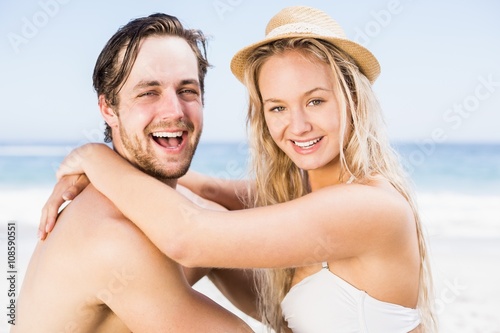 Portrait of young couple sitting together on the beach