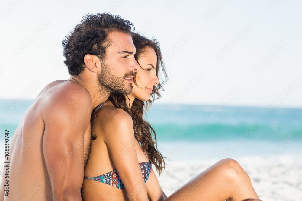 Happy couple sitting on the beach Happy couple sitting on the beach