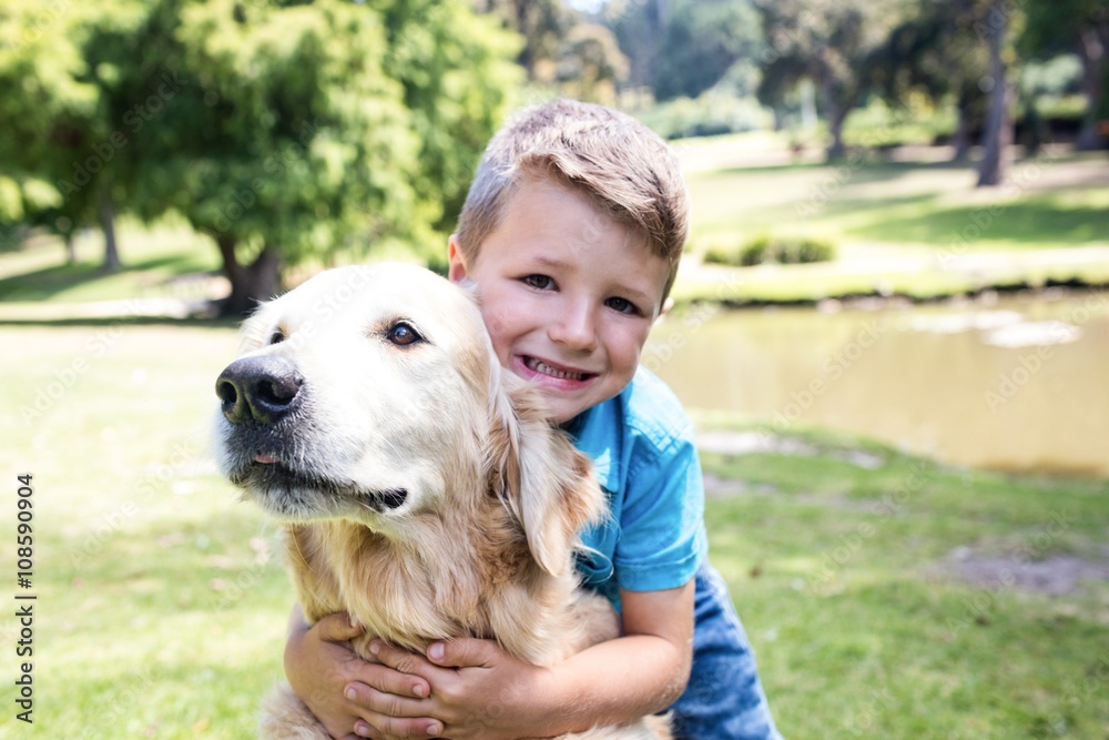 Smiling boy with his pet dog in the park Smiling boy with his pet dog in the park