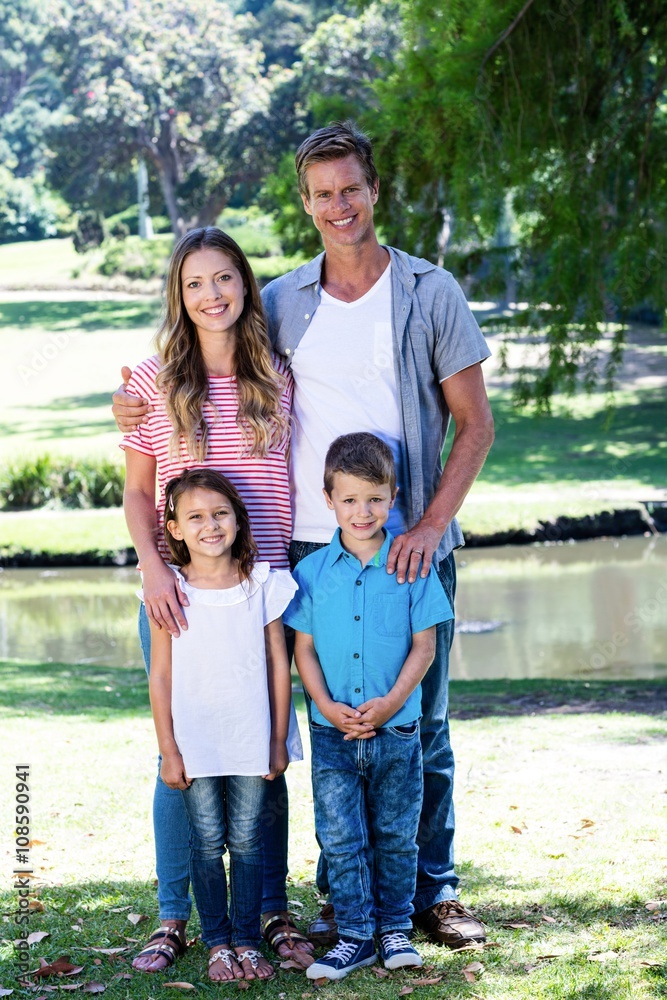 Happy family standing in the park