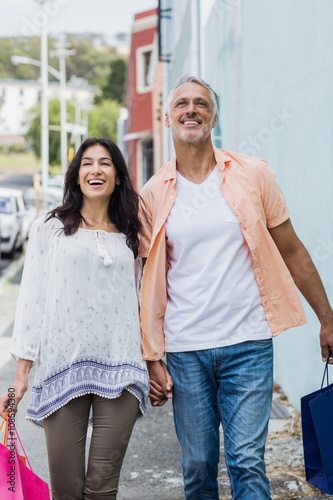 Happy couple walking with shopping bags © WavebreakMediaMicro